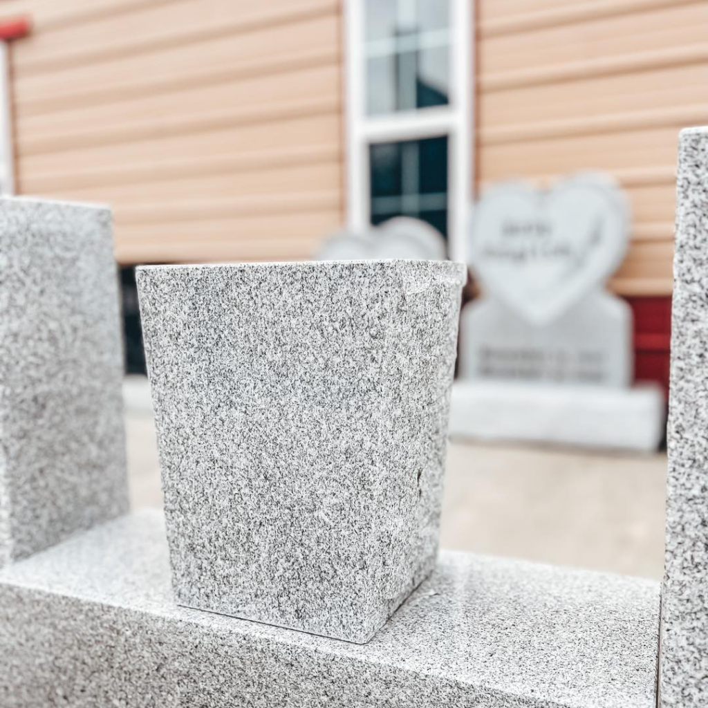 Personal touches and vases beyond the headstone in  Southeast Texas & Southwest Louisiana