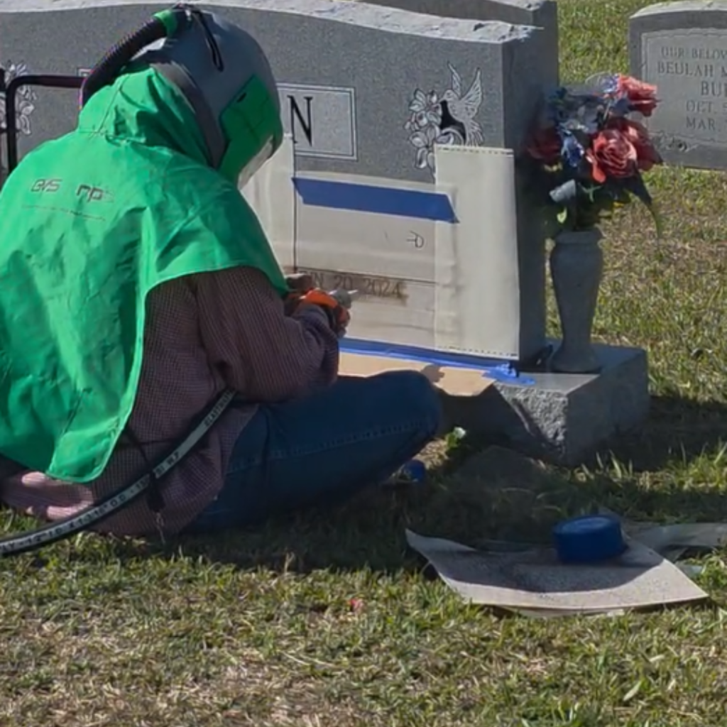 Sandblasting a headstone